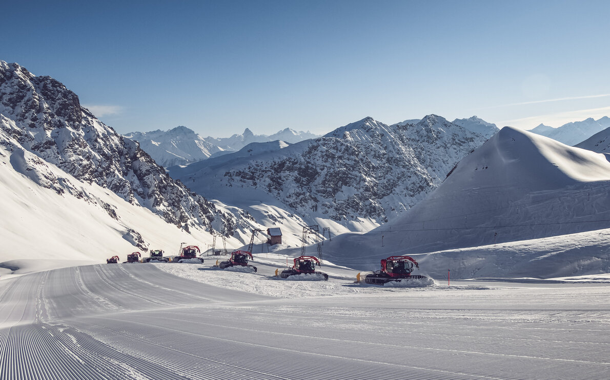 In einer Reihen fahren die zehn Pistenbully über die Piste Hauptertäli Parsenn und präparieren die Piste.  | © Davos Klosters Mountains