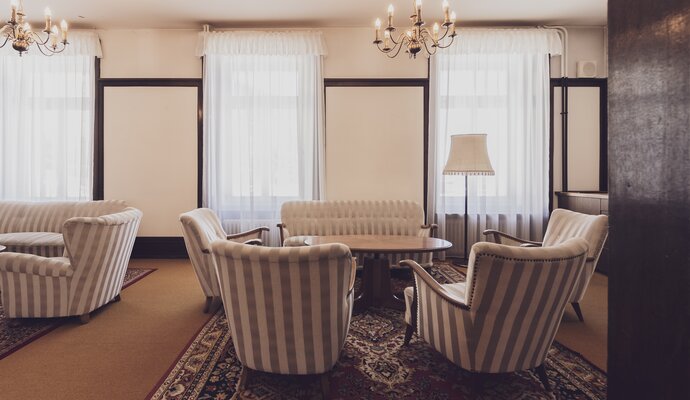 Lounge mit diversen Sitzgelegenheiten, Saloontischchen und Kronleuchtern  | © Davos Klosters  Mountians